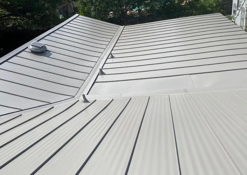 Solar attic fan installed on a metal roof for Roof Ventilation in Bar Harbor